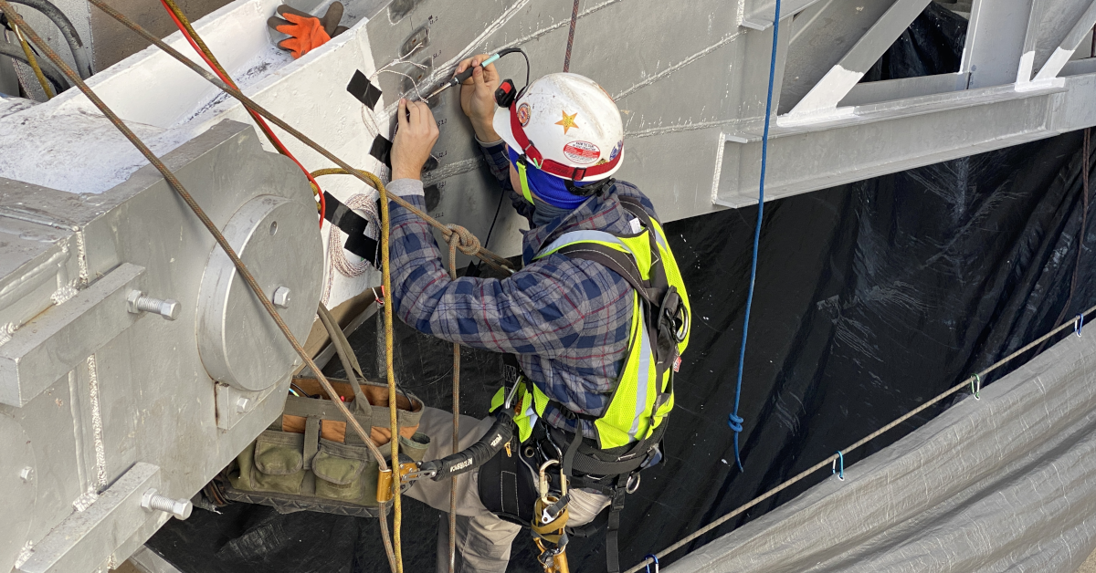 ITM Engineer is suspended mid-air to install strain gauges at Garrison Dam.